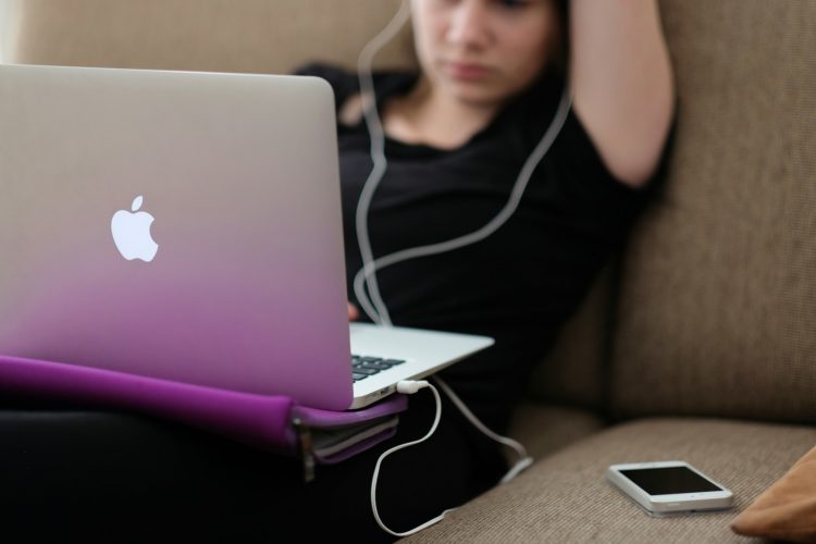 selective focus photography of people sitting on chairs while writing on notebooks