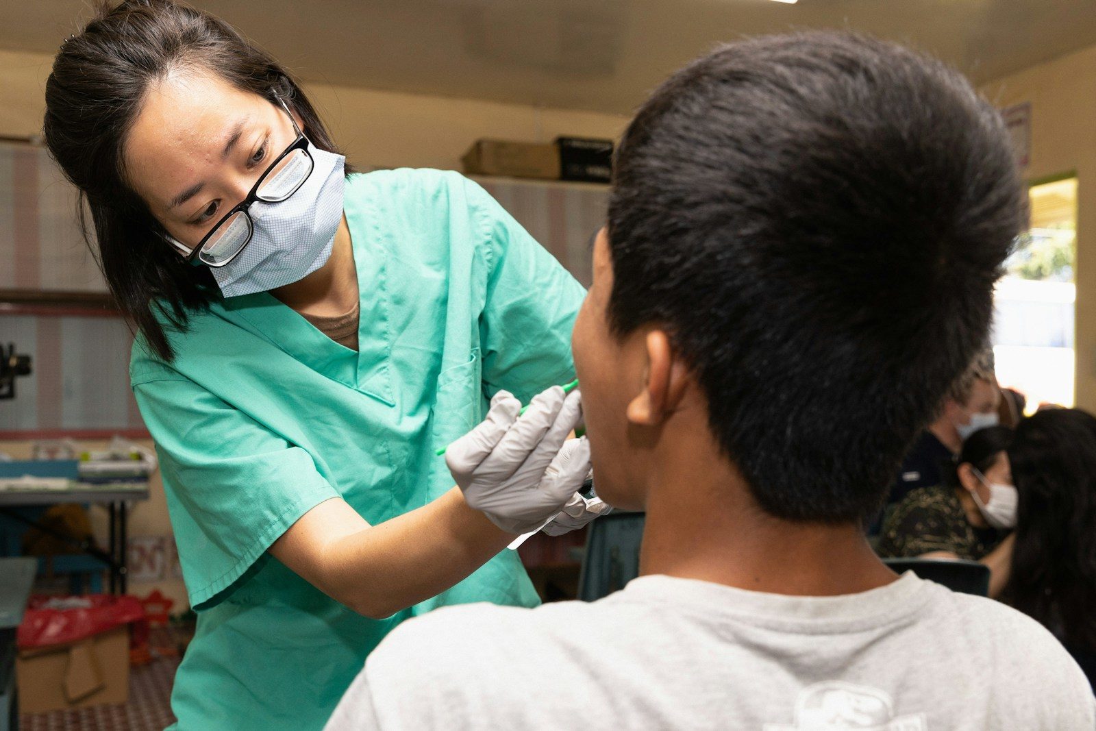 Dentist examining a young patient's teeth